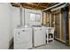 Unfinished basement laundry area with a utility sink, and washer and dryer at 17794 E Bellewood Dr, Aurora, CO 80015