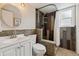 Modern bathroom featuring a stylish shower, decorative stone accent, and vanity sink at 17794 E Bellewood Dr, Aurora, CO 80015