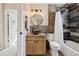 A stylish bathroom featuring a shower-tub, a vanity with granite counter, and modern fixtures at 17794 E Bellewood Dr, Aurora, CO 80015