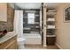 Charming bathroom featuring a shower-tub, a vanity with granite counter, and built-in shelving at 17794 E Bellewood Dr, Aurora, CO 80015