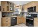 Modern kitchen featuring wood cabinets, granite countertops, stainless steel appliances, and stone backsplash at 17794 E Bellewood Dr, Aurora, CO 80015