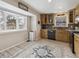 Well-lit kitchen with stainless steel appliances, stylish cabinets, and a bay window at 17794 E Bellewood Dr, Aurora, CO 80015