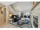 Living room featuring a stone fireplace, staircase, and access to the front door at 17794 E Bellewood Dr, Aurora, CO 80015