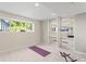 Basement fitness area featuring a window, mirrored wall, and space for exercise equipment at 9294 Melborne Ct, Parker, CO 80134