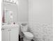 Half bathroom featuring modern fixtures, updated vanity, and stylish wall tiles at 9294 Melborne Ct, Parker, CO 80134