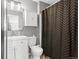 Modern bathroom featuring a white vanity, sleek mirror, and decorative shower curtain at 9294 Melborne Ct, Parker, CO 80134