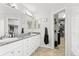 Brightly lit bathroom features double vanity and walk-in closet at 9294 Melborne Ct, Parker, CO 80134
