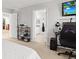 Bright bedroom leading into bathroom, featuring a TV at 9294 Melborne Ct, Parker, CO 80134