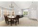 Open-concept dining room featuring a dining table, carpet floors and natural light from large windows at 9294 Melborne Ct, Parker, CO 80134