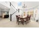Elegant dining room with high ceilings, staircase and windows that flood the room with natural light at 9294 Melborne Ct, Parker, CO 80134