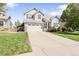Attractive two-story home with a well-manicured lawn and a spacious driveway on a sunny day at 9294 Melborne Ct, Parker, CO 80134