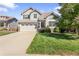 Charming two-story home with a well-maintained lawn and a two-car garage on a sunny day at 9294 Melborne Ct, Parker, CO 80134