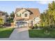 Beautiful two-story home with a well-kept lawn and a two-car garage on a sunny day at 9294 Melborne Ct, Parker, CO 80134
