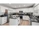 Modern kitchen with white cabinets, granite countertops, and stainless steel appliances at 9294 Melborne Ct, Parker, CO 80134