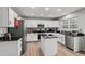 Stylish kitchen showcasing white cabinets, an island with dark countertops, and stainless appliances at 9294 Melborne Ct, Parker, CO 80134