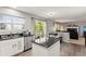 Modern kitchen design with island and an adjacent living area that is drenched in light at 9294 Melborne Ct, Parker, CO 80134