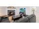 Comfortable living room featuring a fireplace, TV, sofa and natural light from large windows at 9294 Melborne Ct, Parker, CO 80134