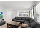 Cozy living room featuring an open layout with modern dark furniture and natural light at 9294 Melborne Ct, Parker, CO 80134