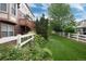 Well-maintained backyard with green grass, a white fence, and mature trees, creating a serene outdoor space at 2959 W 110Th Pl, Westminster, CO 80234