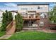 Lovely backyard view showcases a deck, patio, waterfall feature, and manicured lawn at 2959 W 110Th Pl, Westminster, CO 80234