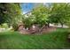 Picturesque backyard with a patio, deck, waterfall feature, lush landscaping, and mature trees at 2959 W 110Th Pl, Westminster, CO 80234