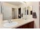 Bathroom featuring double sinks, ample counter space, and a large mirror at 2959 W 110Th Pl, Westminster, CO 80234