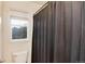 Bathroom showcasing a shower with a textured curtain and a bright window at 2959 W 110Th Pl, Westminster, CO 80234