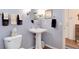 Powder room with pedestal sink, decorative mirror, and stylish fixtures at 2959 W 110Th Pl, Westminster, CO 80234