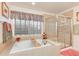 Luxurious bathroom featuring a soaking tub, separate shower, and ample natural light at 2959 W 110Th Pl, Westminster, CO 80234