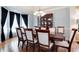 The dining room boasts black curtains and a wooden hutch, and the wooden table seats eight at 2959 W 110Th Pl, Westminster, CO 80234