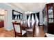 This dining room features a tray ceiling, hardwood floors, and a large wooden table with seating for eight at 2959 W 110Th Pl, Westminster, CO 80234