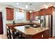 This kitchen features an island cooktop, stainless steel appliances, and beautiful wooden cabinets at 2959 W 110Th Pl, Westminster, CO 80234