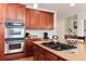 This kitchen features stainless steel appliances and a cooktop island at 2959 W 110Th Pl, Westminster, CO 80234