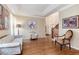 Open-concept living room featuring hardwood floors, a tray ceiling and access to the foyer and staircase at 2959 W 110Th Pl, Westminster, CO 80234