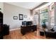 Office with dark wood desk, hardwood floors, a large window and a comfortable black chair at 2959 W 110Th Pl, Westminster, CO 80234