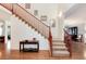 View of the staircase with hardwood floors, carpeted treads, and wood railing at 2959 W 110Th Pl, Westminster, CO 80234