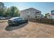 Back of unit with parking and a modern black car, with a private balcony on the home's second floor at 7978 Chase Cir # E, Arvada, CO 80003