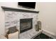 Cozy fireplace with decorative brick surround and modern accents at 7978 Chase Cir # E, Arvada, CO 80003