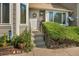Close-up of a welcoming front door with a wreath, complemented by lush greenery at 7978 Chase Cir # E, Arvada, CO 80003