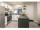 Updated kitchen with white cabinetry, stainless steel appliances, and a stylish marble backsplash at 7978 Chase Cir # E, Arvada, CO 80003