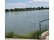 Scenic lake view showcasing serene waters and lush green trees in the background at 7978 Chase Cir # E, Arvada, CO 80003