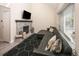 Inviting living room featuring a brick fireplace and a comfortable, modern black sectional sofa at 7978 Chase Cir # E, Arvada, CO 80003
