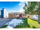 Front view of a ranch home with a red door and snowy lawn at 8923 Prickly Pear Cir, Parker, CO 80134