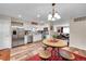 Well-lit kitchen featuring stainless appliances, stylish backsplash, and a breakfast nook with table and seating at 2301 E Fremont Ave # W02, Centennial, CO 80122
