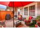 Cozy patio features comfortable seating, a red umbrella, and outdoor grill, perfect for relaxing or entertaining at 2301 E Fremont Ave # W02, Centennial, CO 80122