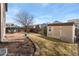 Backyard view of a patio, shed, wood fence, and treed lot at 6280 Snowberry Ave, Firestone, CO 80504