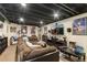 Finished basement features a large entertainment center with a sectional sofa at 6280 Snowberry Ave, Firestone, CO 80504