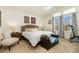 Bright bedroom with vaulted ceiling, large window, comfortable bed and neutral decor at 6280 Snowberry Ave, Firestone, CO 80504