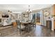 Elegant dining room featuring hardwood floors, a modern chandelier, and sliding door access to backyard at 6280 Snowberry Ave, Firestone, CO 80504