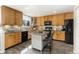Functional kitchen with wood cabinets, modern appliances, and a central island with seating at 6280 Snowberry Ave, Firestone, CO 80504